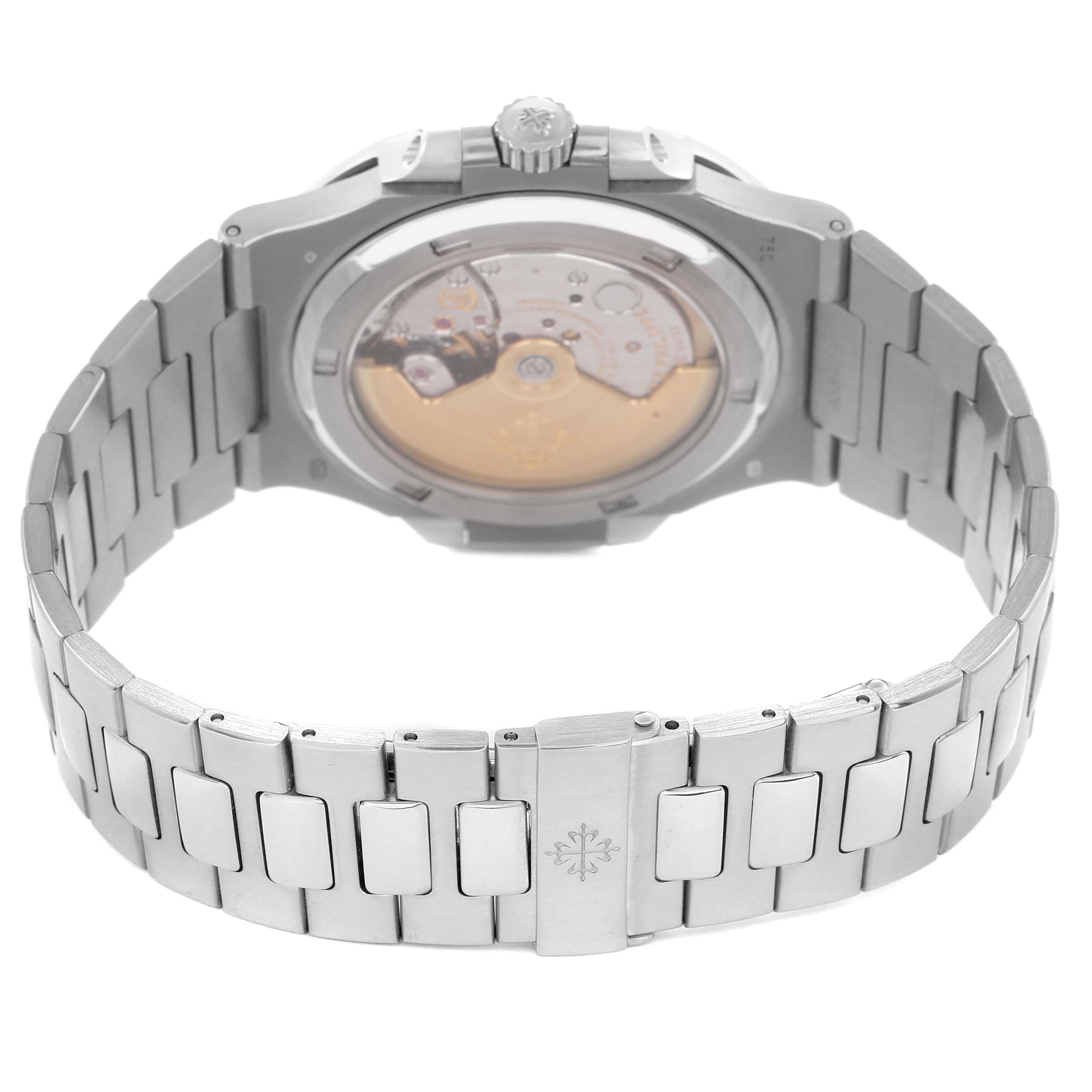 The image shows the back view of a Patek Philippe Nautilus model 5713 men
s watch, highlighting the exhibition case back and the metal bracelet.