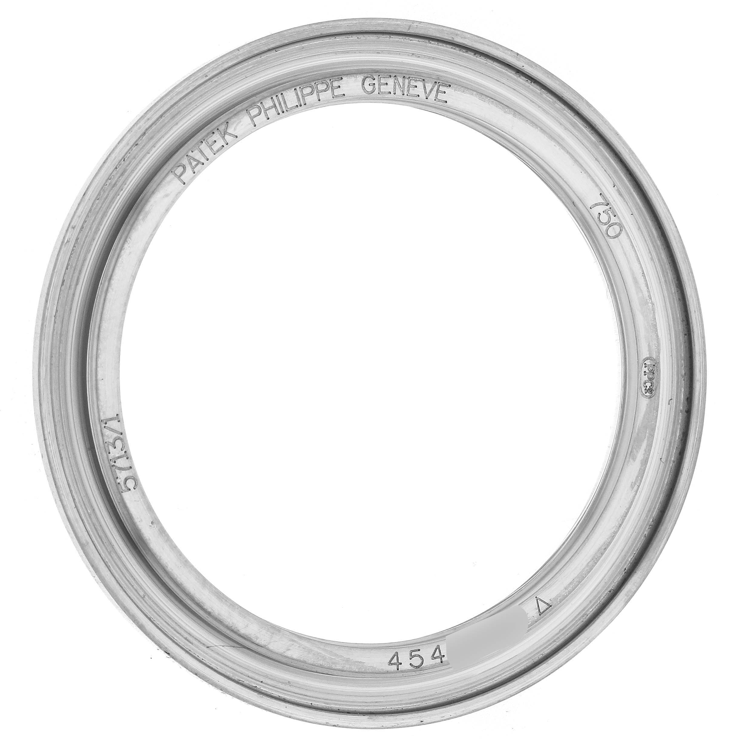 The image shows a bezel from a Patek Philippe Nautilus model 5713 men
s watch, viewed from above, displaying engraved details on the inner rim.