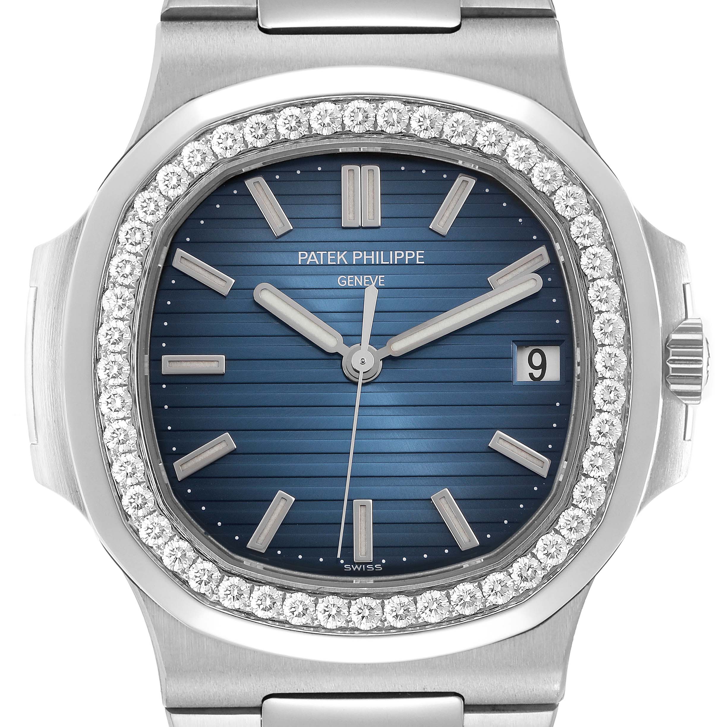 The image shows a front view of the Patek Philippe Nautilus 5713 men
s watch, highlighting the blue dial, diamond-set bezel, and date window.