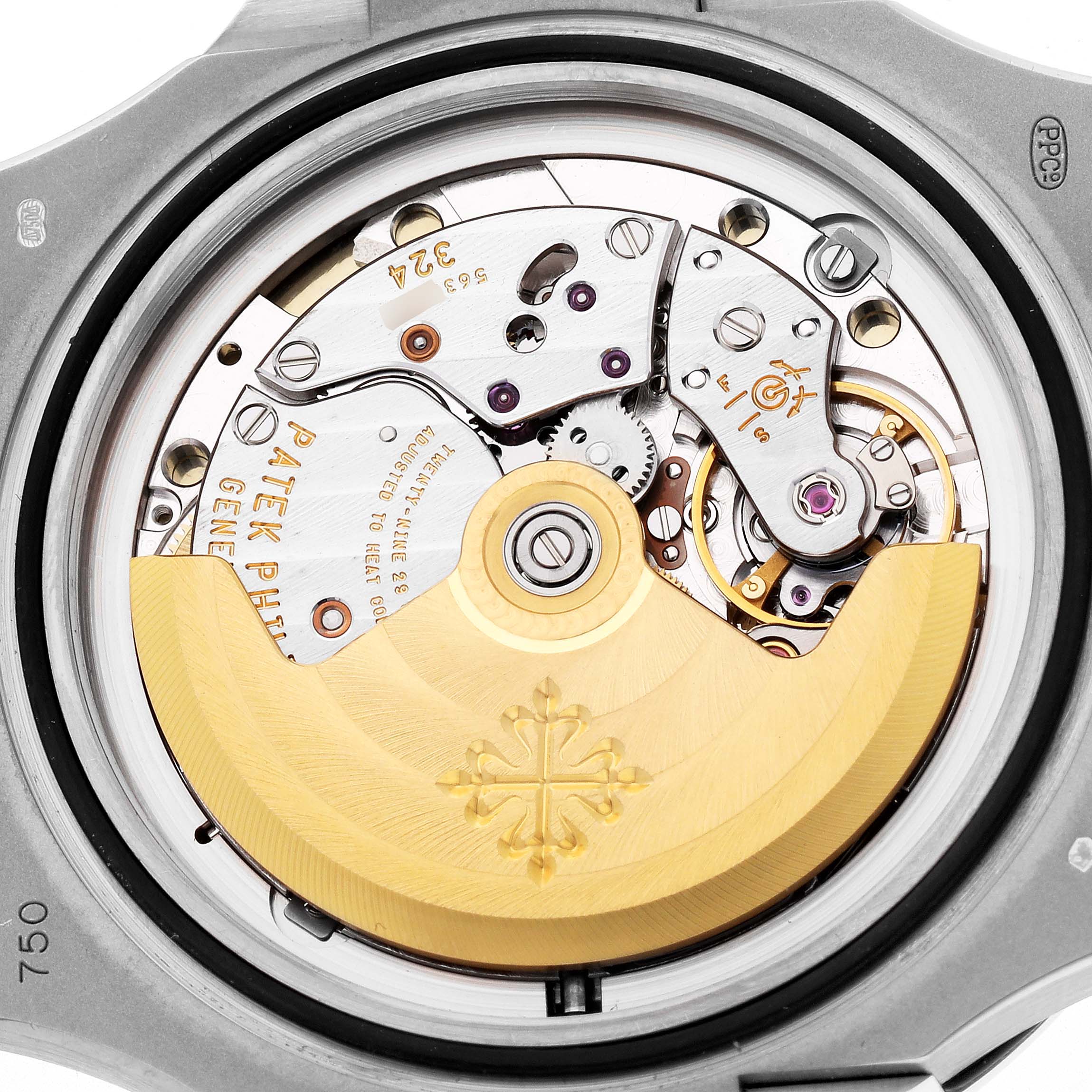 The image shows the movement of a Patek Philippe Nautilus model 5713 from the back, displaying the rotor and intricate mechanical components.