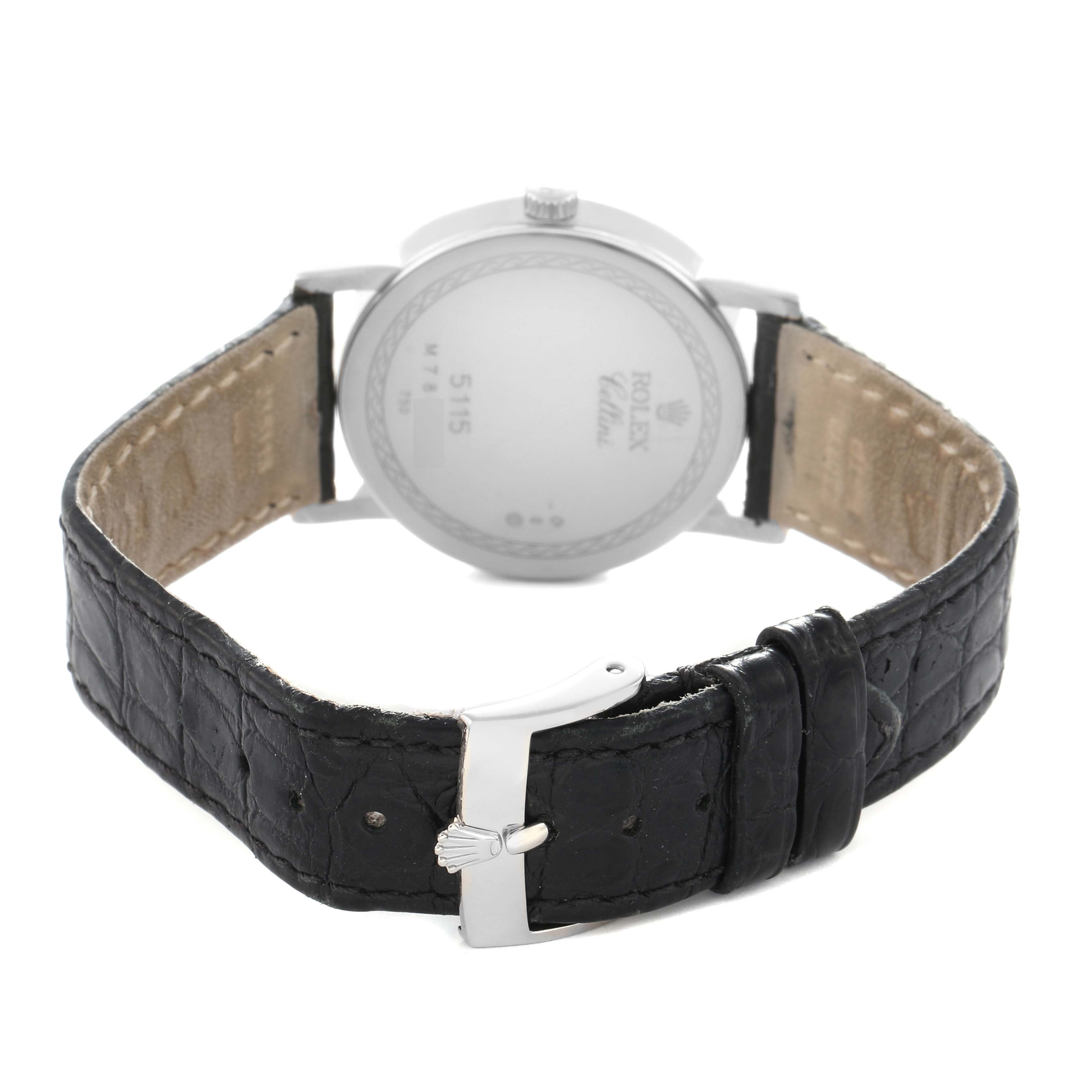 The image shows the back of a Rolex Cellini model 5115/9 men
s watch, highlighting the case back and the black leather strap with a buckle.