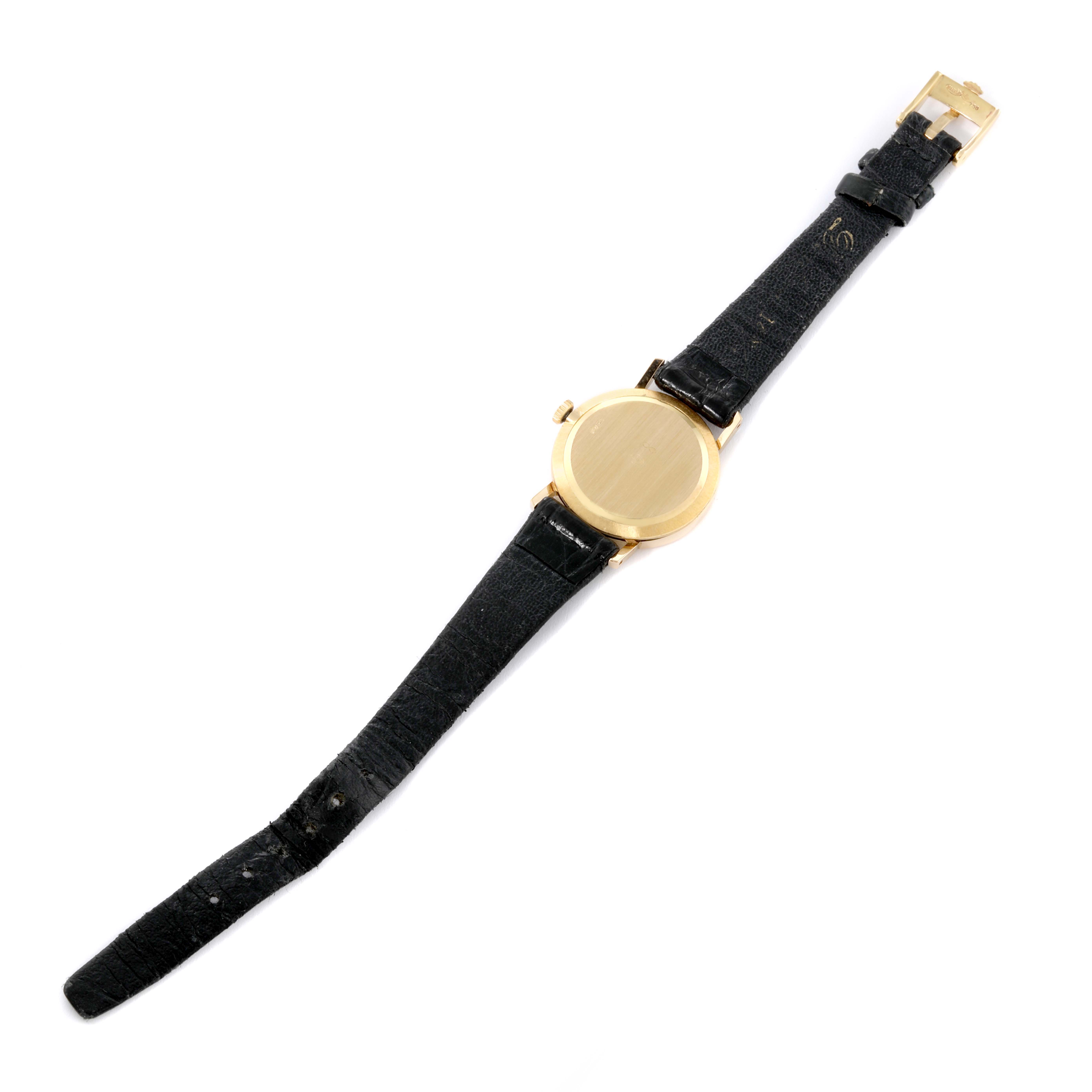 The image shows the back and strap of a Rolex Cellini 5109 Women's Yellow Gold White Dial 5109 Women's Yellow Gold White Dial watch laid flat with a focus on its gold case and black leather straps.