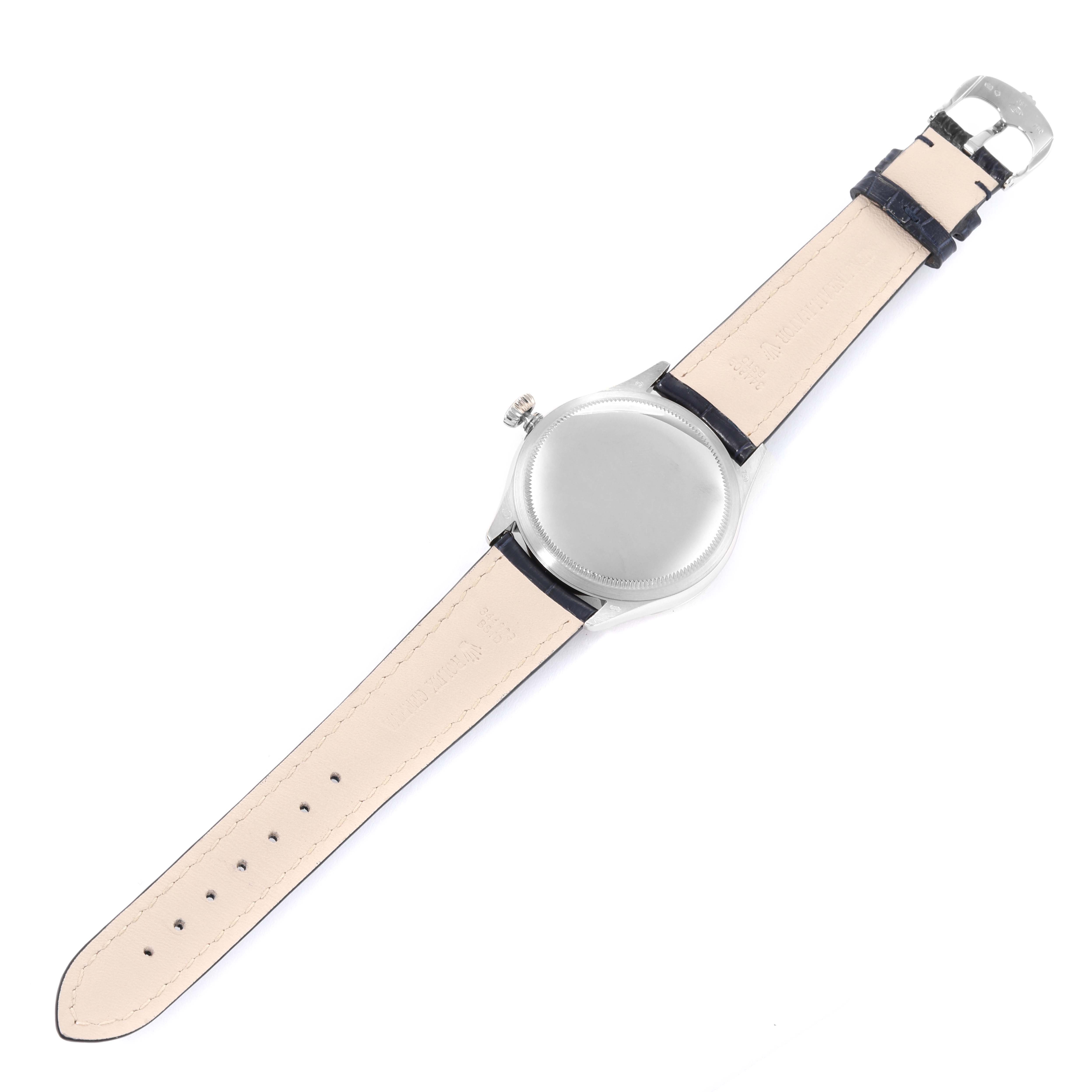 This image shows the back of a Rolex Cellini 50509 Men's White Gold White Dial 50509 Men's White Gold White Dial watch, including its case, crown, and leather strap with a buckle, from a top-down angle.