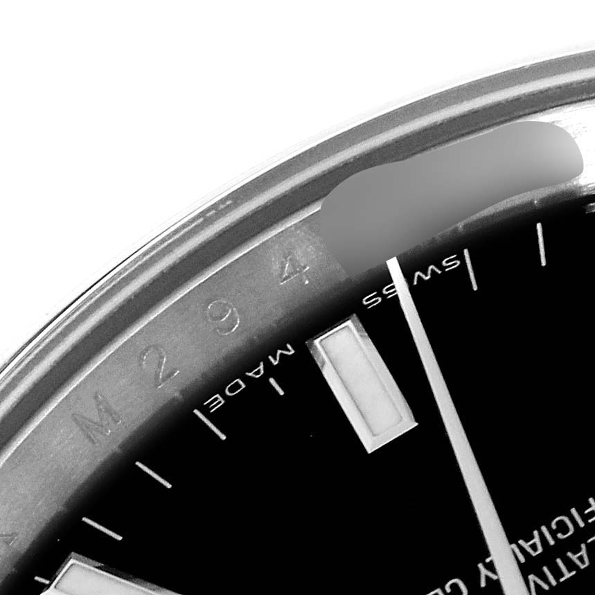 This image shows a close-up of the dial and edge of the bezel of a Rolex Date 115200 Men
s Stainless Steel Black Dial 115200 Men
s Stainless Steel Black Dial model watch.