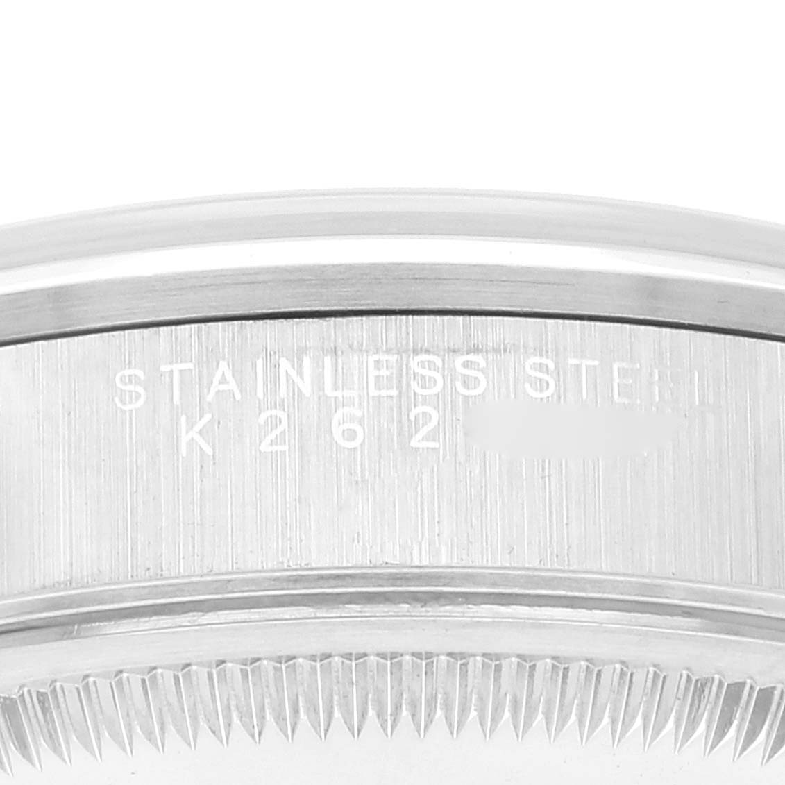 The image shows a close-up of the case back edge of a Rolex Date 15200 Men's Stainless Steel Black Dial 15200 Men's Stainless Steel Black Dial watch, highlighting the stainless steel material and serial number.