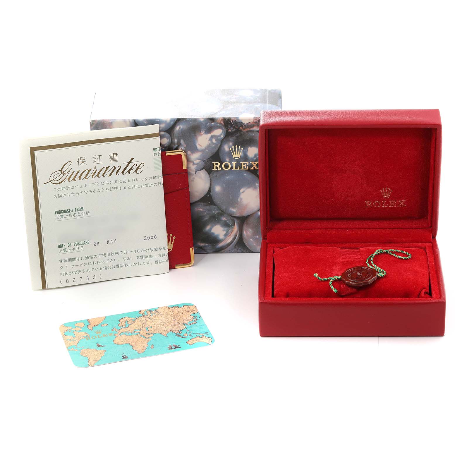 The image shows accessories for the Rolex Datejust 79174 Women's Stainless Steel Black Dial 79174 Women's Stainless Steel Black Dial, including its box, guarantee card, booklet, and a seal.