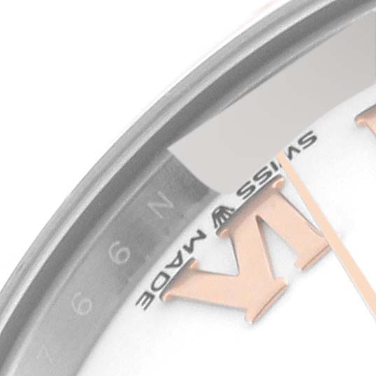 The image shows a close-up of the dial and hour markers of a Mid-Size Rolex watch, highlighting the numeral VI and "Swiss Made."