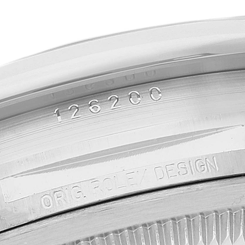 The image shows a close-up of the Rolex Datejust 126200 Men's Stainless Steel Silver Dial 126200 Men's Stainless Steel Silver Dial model, displaying the serial and model numbers engraved on the inner bezel.