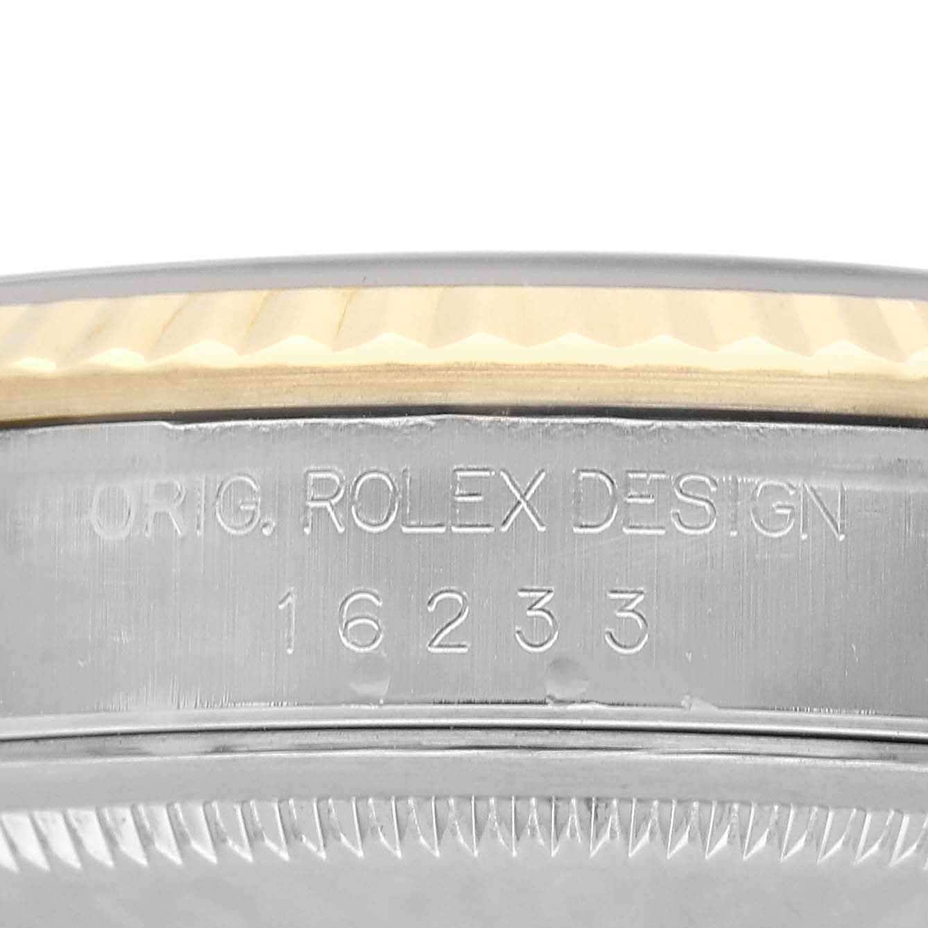 The image shows a close-up of the side bezel with engravings on the Rolex Datejust 16233 Men's Steel and Gold (two tone) White Dial model.