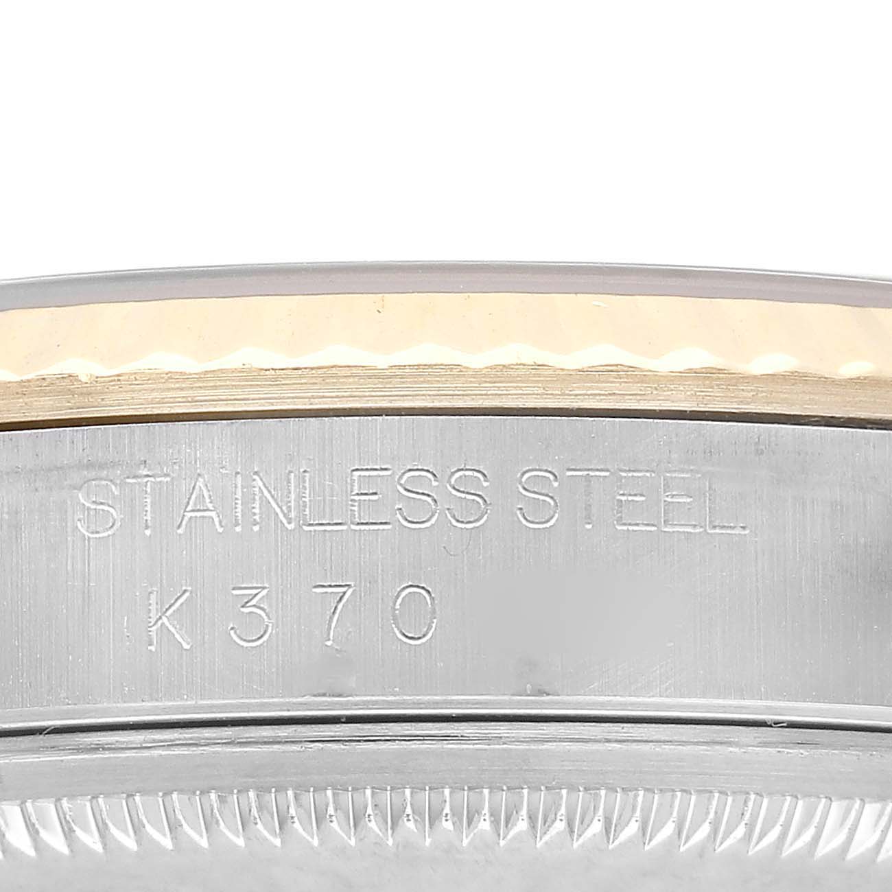 The image shows a close-up side view of a Rolex Datejust 16233 Men's Steel and Gold (two tone) White Dial watch, highlighting the stainless steel part with engraving.