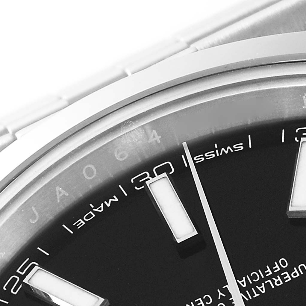 The image shows a close-up of the dial and bezel of a Rolex Datejust 41 126300 Men's Stainless Steel Black Dial 126300 Men's Stainless Steel Black Dial watch, focusing on the 12 and 1-hour markers.