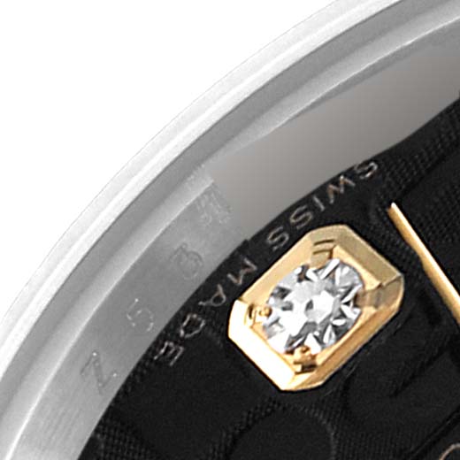 This image shows a close-up of the Rolex Datejust 179173 Women's Steel and Gold (two tone) Black Dial 179173 Women's Steel and Gold (two tone) Black Dial watch, focusing on its side case and part of the dial with a diamond accent.