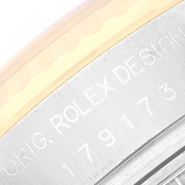This close-up image shows part of the engraved caseback of a Rolex Datejust 179173 Women's Steel and Gold (two tone) Black Dial 179173 Women's Steel and Gold (two tone) Black Dial watch.