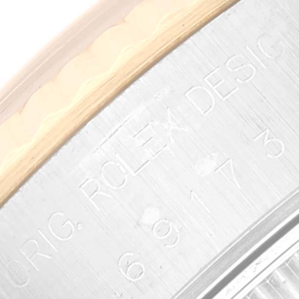 This image shows a close-up of the engraved serial number on the side of a Rolex Datejust 69173 Women's Steel and Gold (two tone) Blue Dial 69173 Women's Steel and Gold (two tone) Blue Dial watch.