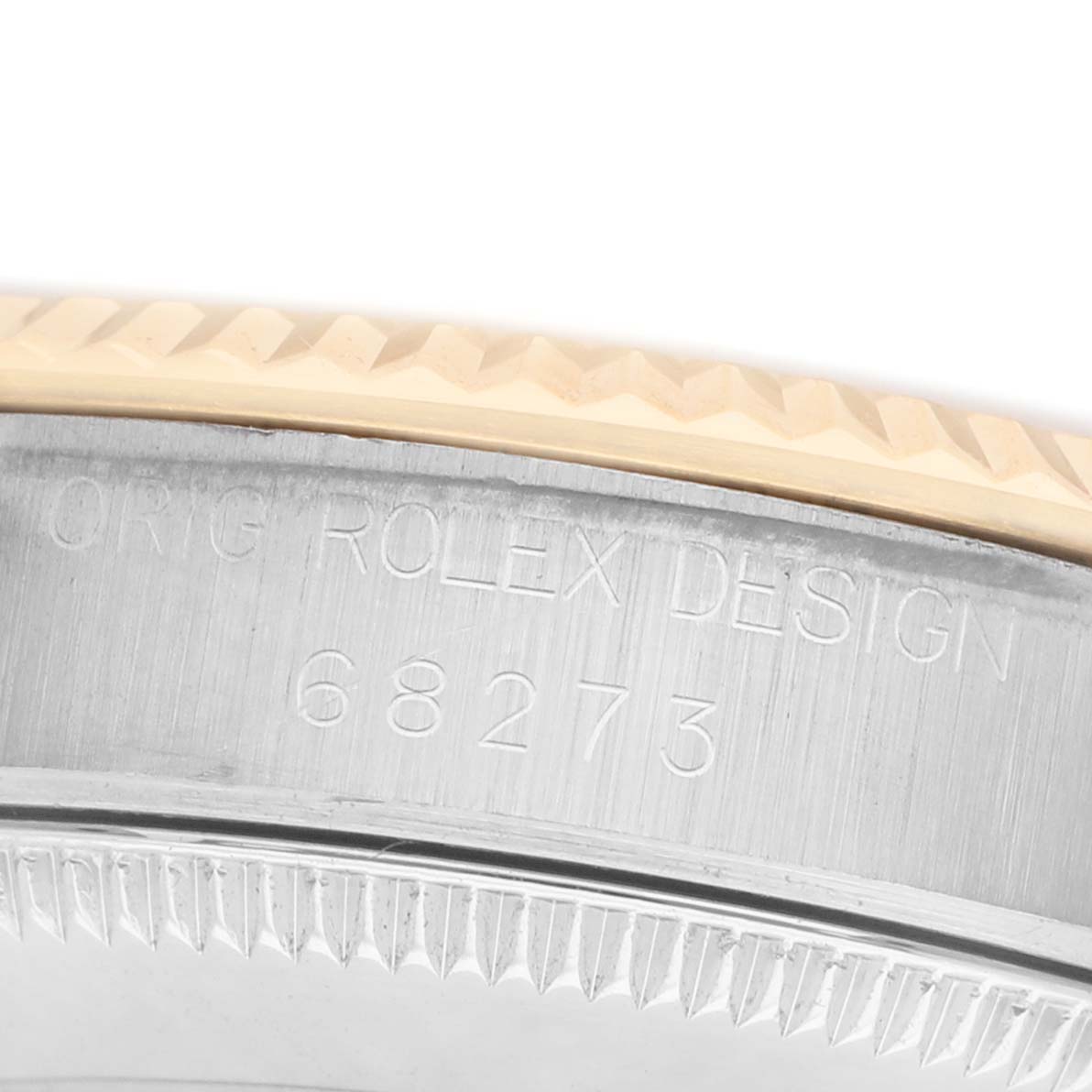 The image shows a detailed close-up of the bezel and case edge of a Rolex Mid-Size 68273 Women's Steel and Gold (two tone) Champagne Dial watch, showcasing its textured design.