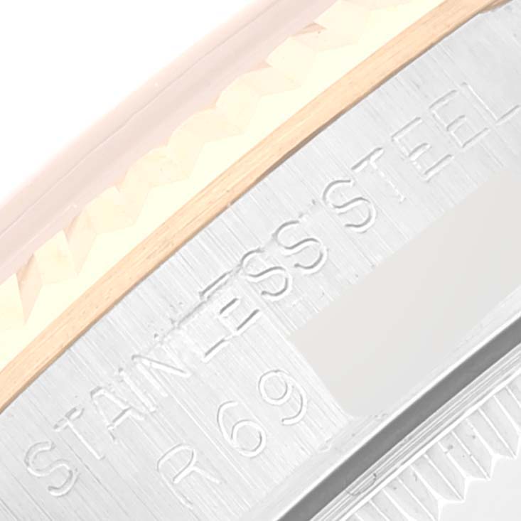The image shows a close-up of the case edge and engraving for the mid-size Rolex watch, highlighting the "STAINLESS STEEL" marking.