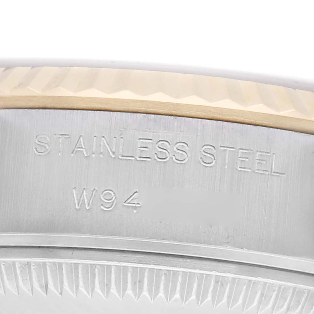 The image shows a close-up of the side of a Rolex Datejust watch, model 69173, focusing on the stainless steel case with engraved markings.
