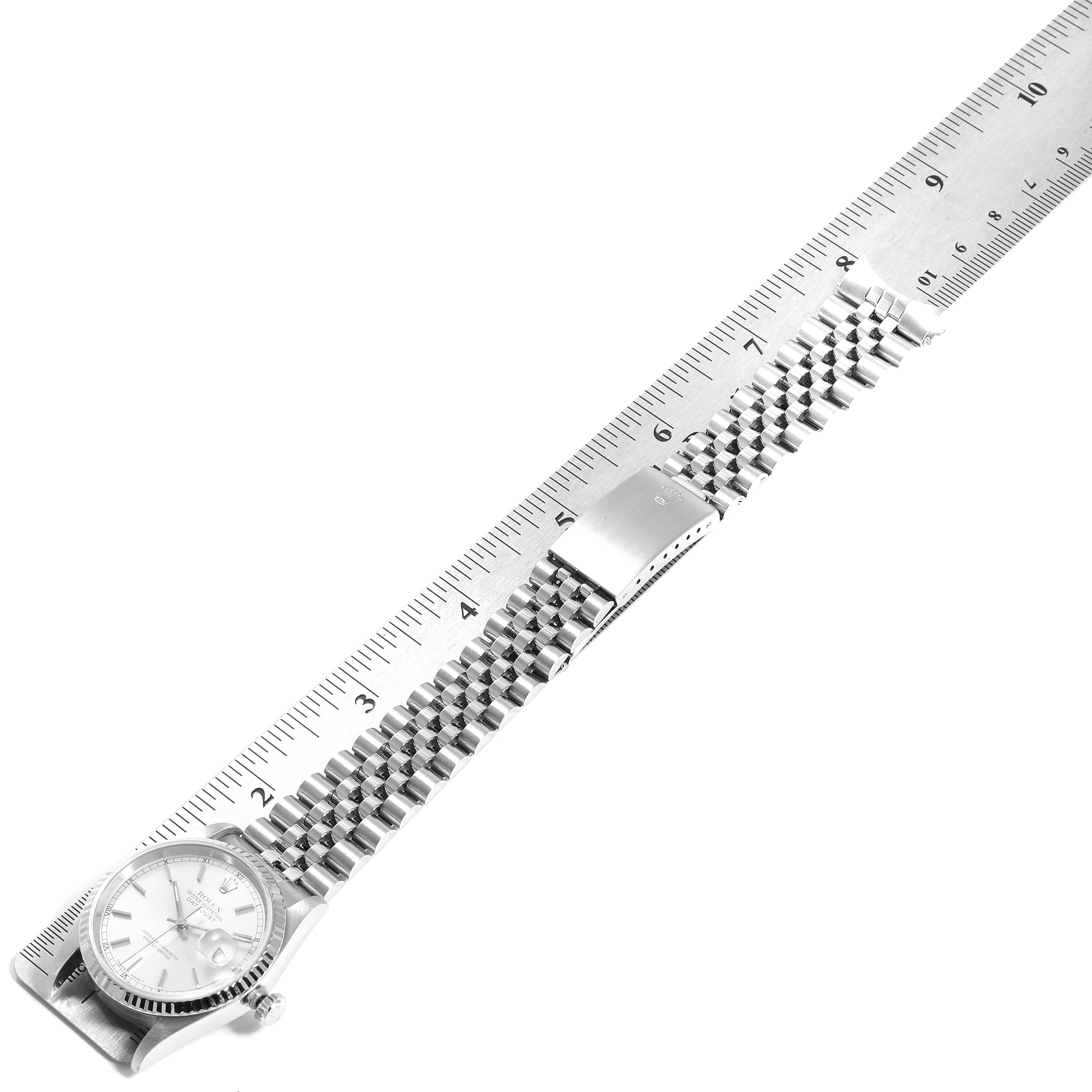 This image shows the Rolex Datejust 16234 Men's Stainless Steel Silver Dial 16234 Men's Stainless Steel Silver Dial watch lying flat, highlighting its face, bezel, and bracelet, measured against a ruler.