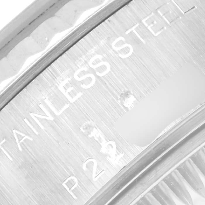 The image shows an extreme close-up of the engraved text on the stainless steel back of a Rolex Datejust 79174 Women
s Stainless Steel Mother of Pearl Dial 79174 Women
s Stainless Steel Mother of Pearl Dial watch.