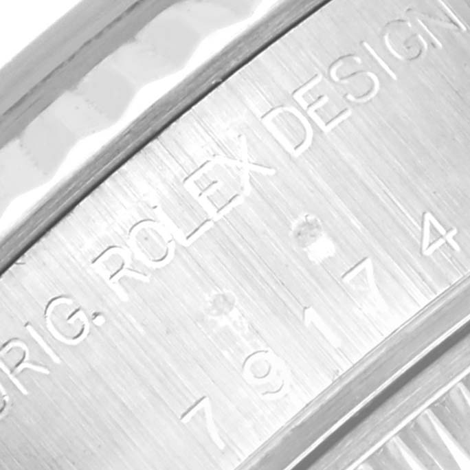 The image shows a close-up of the engraved text on the Rolex Datejust 79174 Women
s Stainless Steel Mother of Pearl Dial 79174 Women
s Stainless Steel Mother of Pearl Dial watch
s inner case.