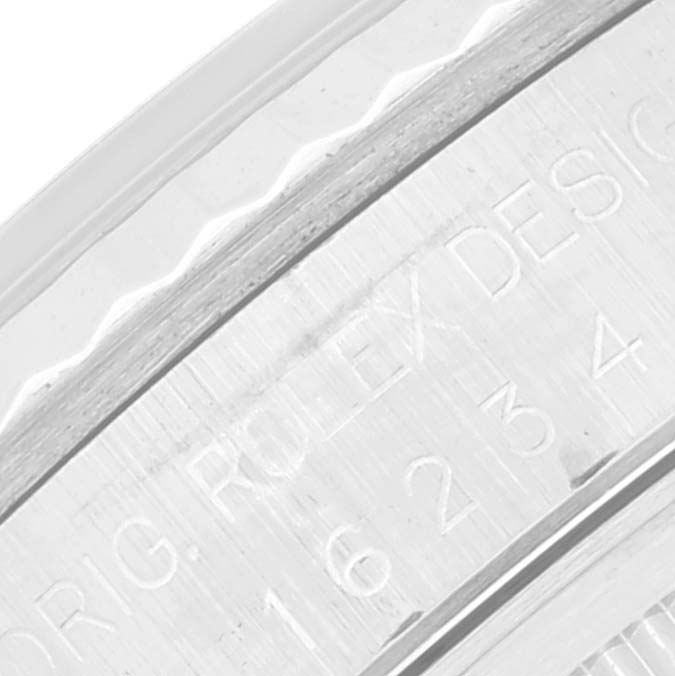A close-up view of the Rolex Datejust 16234 Men's Stainless Steel Silver Dial 16234 Men's Stainless Steel Silver Dial model's case showing part of the edge and engraved text.