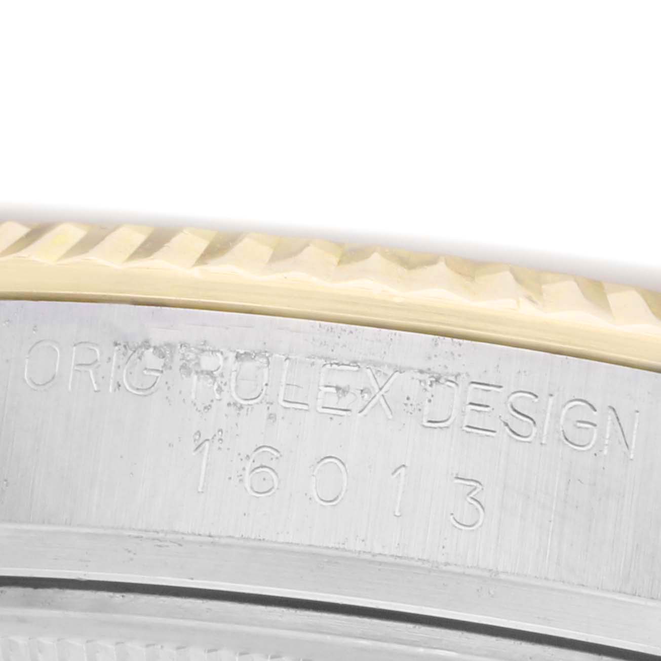 The image shows a close-up of the engraving on the side of a Rolex Datejust model 16013, highlighting the model number and part of the fluted bezel.