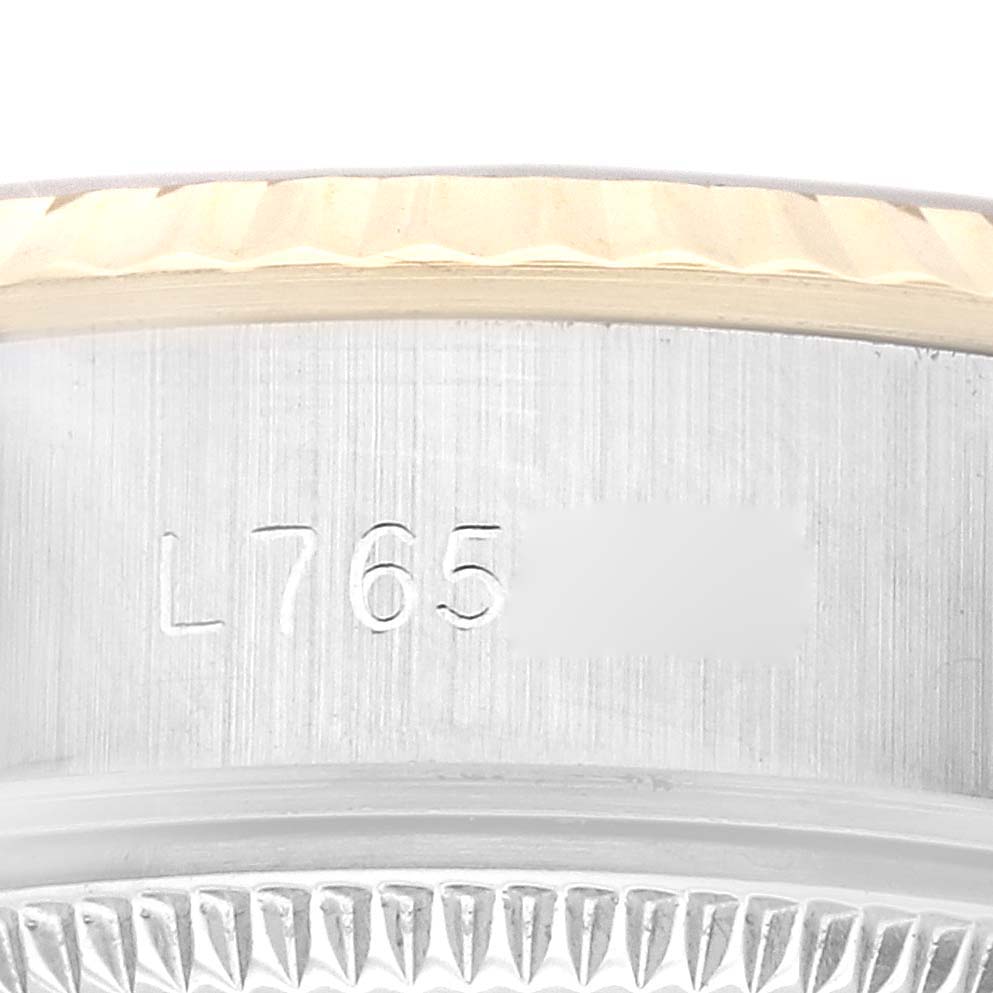 The image shows a close-up of the serial number engraved on the case side of a Rolex Datejust 69173G Women's Steel and Gold (two tone) Champagne Dial 69173G Women's Steel and Gold (two tone) Champagne Dial watch, including part of the bezel.