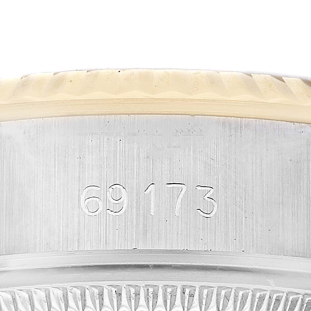 The image shows a close-up of the side of the Rolex Datejust 69173G Women's Steel and Gold (two tone) Champagne Dial 69173G Women's Steel and Gold (two tone) Champagne Dial watch, highlighting the model number 69173 and part of the fluted bezel.