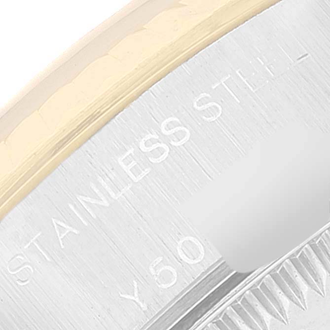 This image shows a close-up of the etched "STAINLESS STEEL" text on the Datejust model by Rolex.