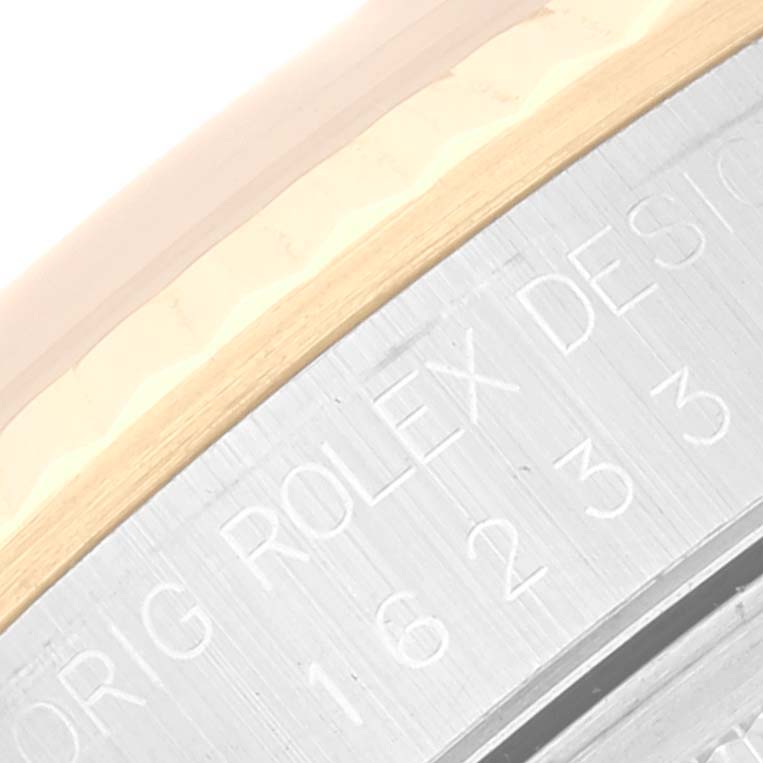 The image shows a close-up angle of the Rolex Datejust 16233 Men's Steel and Gold (two tone) Beige Dial 16233 Men's Steel and Gold (two tone) Beige Dial model, focusing on the case side with engraved text.