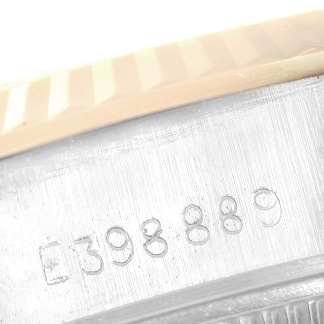 This image shows a close-up of the serial number and part of the bezel on a Rolex Datejust 69173 Women
s Steel and Gold (two tone) Champagne Dial 69173 Women
s Steel and Gold (two tone) Champagne Dial watch.