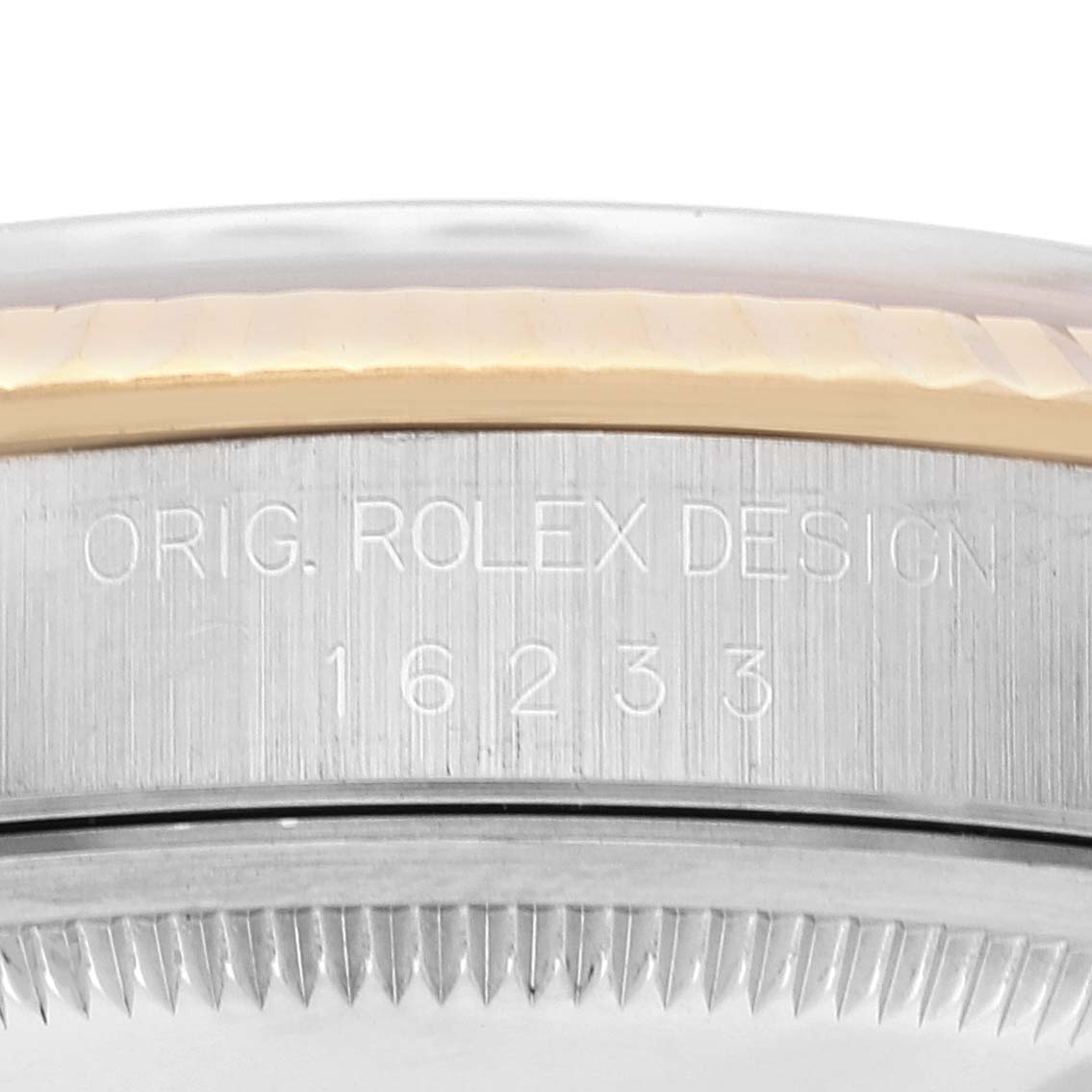 Close-up of a Rolex Datejust 16233 Men's Steel and Gold (two tone) Silver Dial 16233 Men's Steel and Gold (two tone) Silver Dial case's side showing the model number and "ORIG. ROLEX DESIGN" engraving.