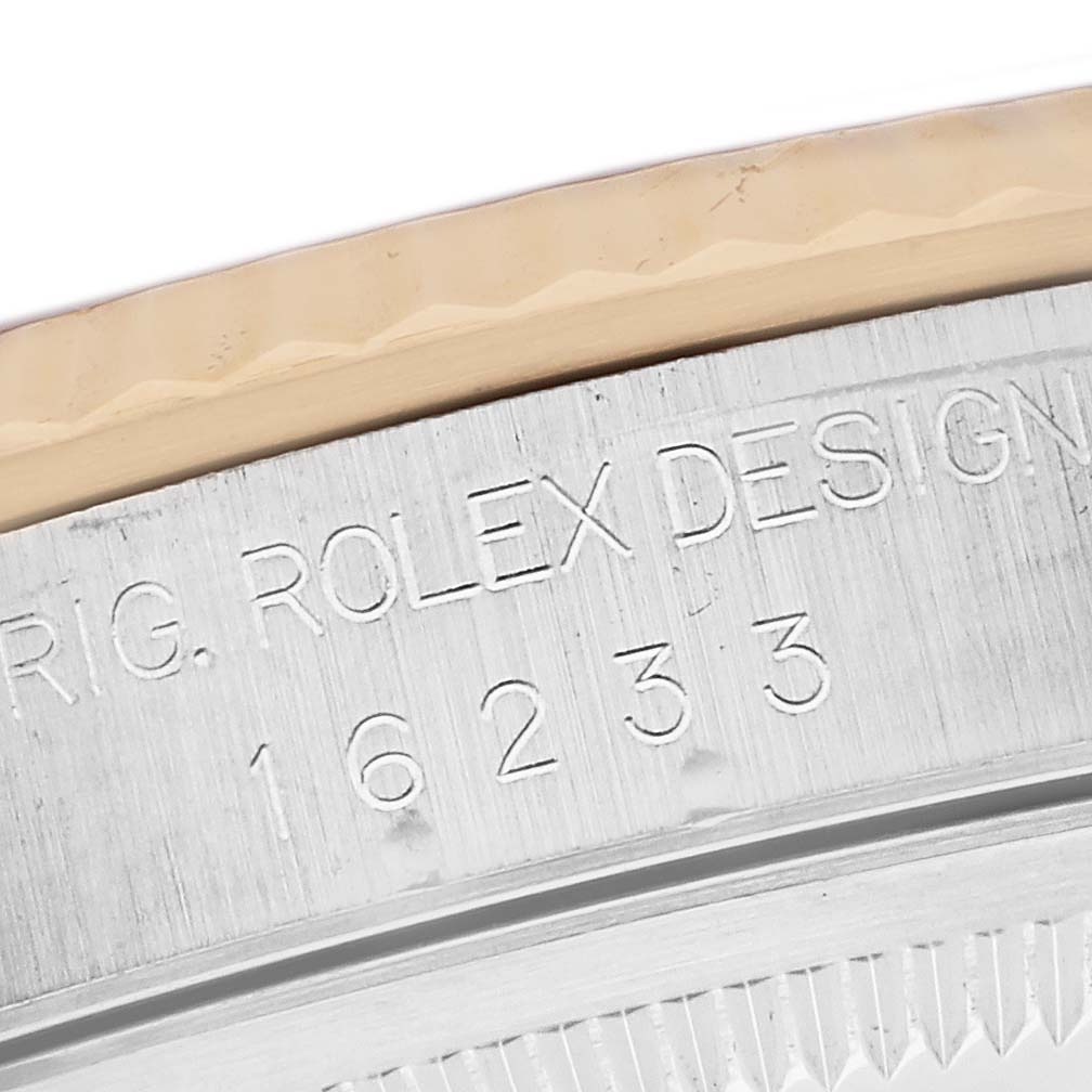The image shows an angled close-up of the casing edge, bezel, and engraved model number "16233" of the Rolex Datejust watch.