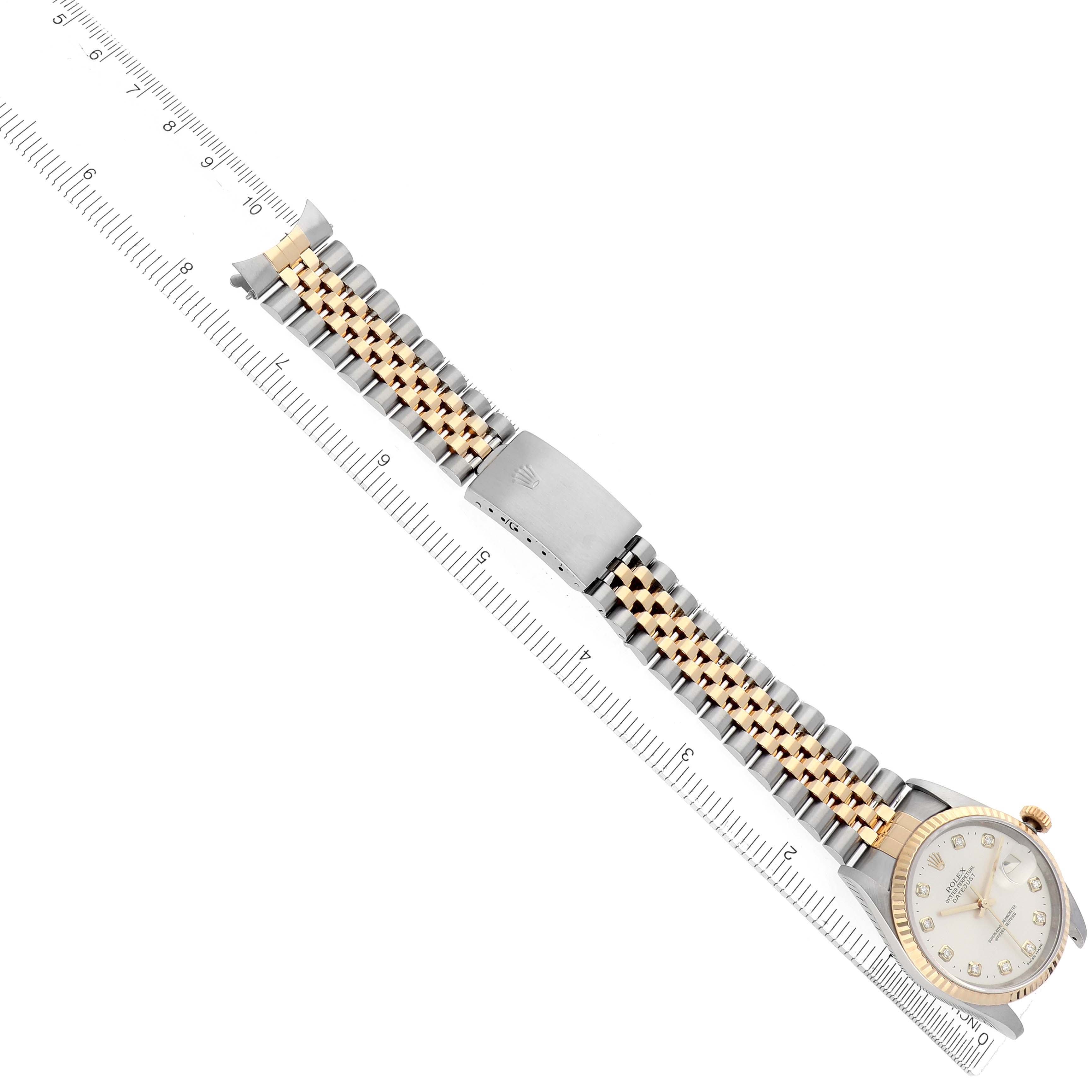 The Rolex Datejust model 16233 men
s watch is shown at a diagonal angle, featuring its jubilee bracelet and part of the face, alongside a ruler for scale.