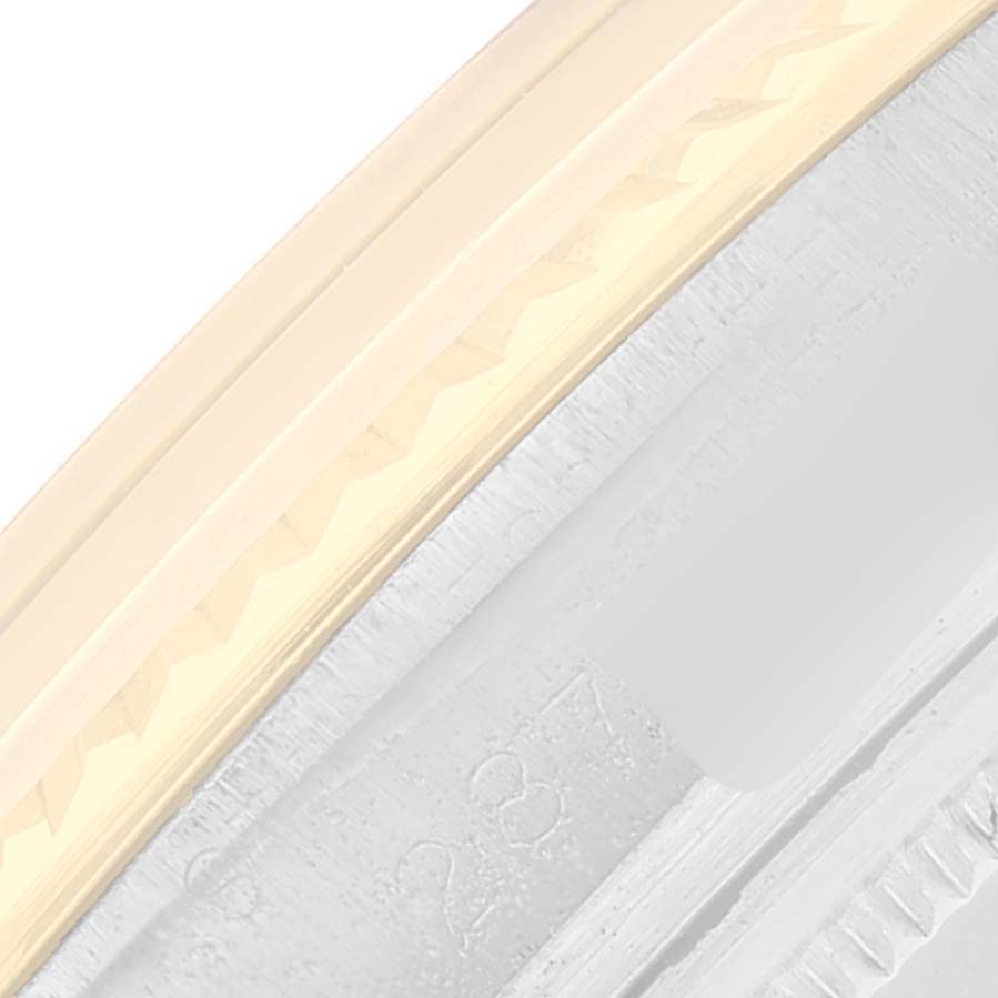 This close-up image shows a part of the bezel and case of a Rolex Datejust 1601 Men
s Steel and Gold (two tone) Champagne Dial 1601 Men
s Steel and Gold (two tone) Champagne Dial watch at an angle.