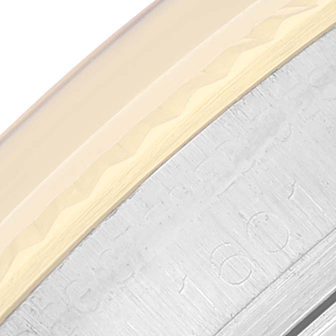 This close-up image shows the edge of the bezel and part of the case for a Rolex Datejust 1601 Men
s Steel and Gold (two tone) Champagne Dial 1601 Men
s Steel and Gold (two tone) Champagne Dial watch.
