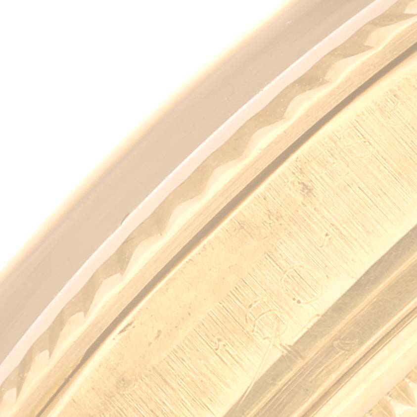 This close-up image shows a detailed view of the bezel and part of the case of a Vintage Collection model by Rolex.