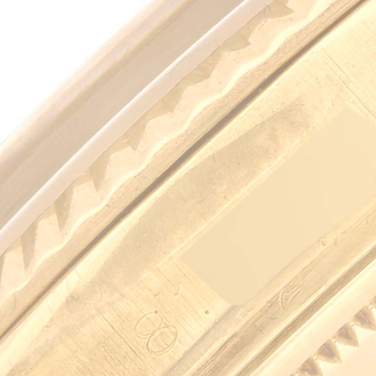 This is an angled close-up shot of the outer rim of a Rolex Vintage Collection 1601 Men's Yellow Gold Champagne Dial 1601 Men's Yellow Gold Champagne Dial watch bezel.