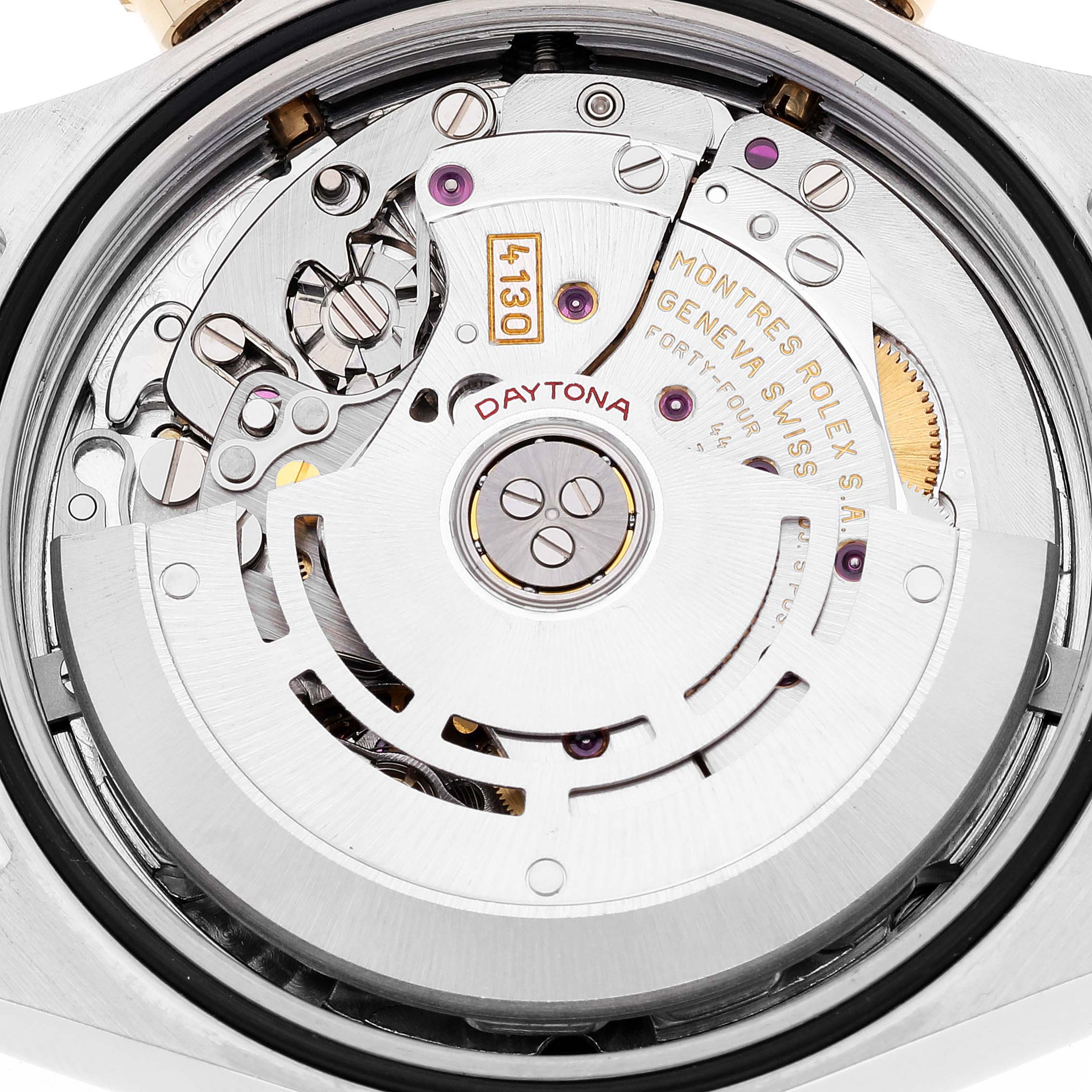The image shows a close-up view of the movement and intricate inner workings of a Rolex Daytona 116523 Men's Steel and Gold (two tone) Black Dial 116523 Men's Steel and Gold (two tone) Black Dial watch.