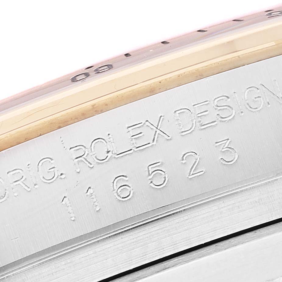 This close-up image shows the side engraving of the watch case with model number 116523 on a Rolex Daytona 116523 Men's Steel and Gold (two tone) Black Dial 116523 Men's Steel and Gold (two tone) Black Dial.