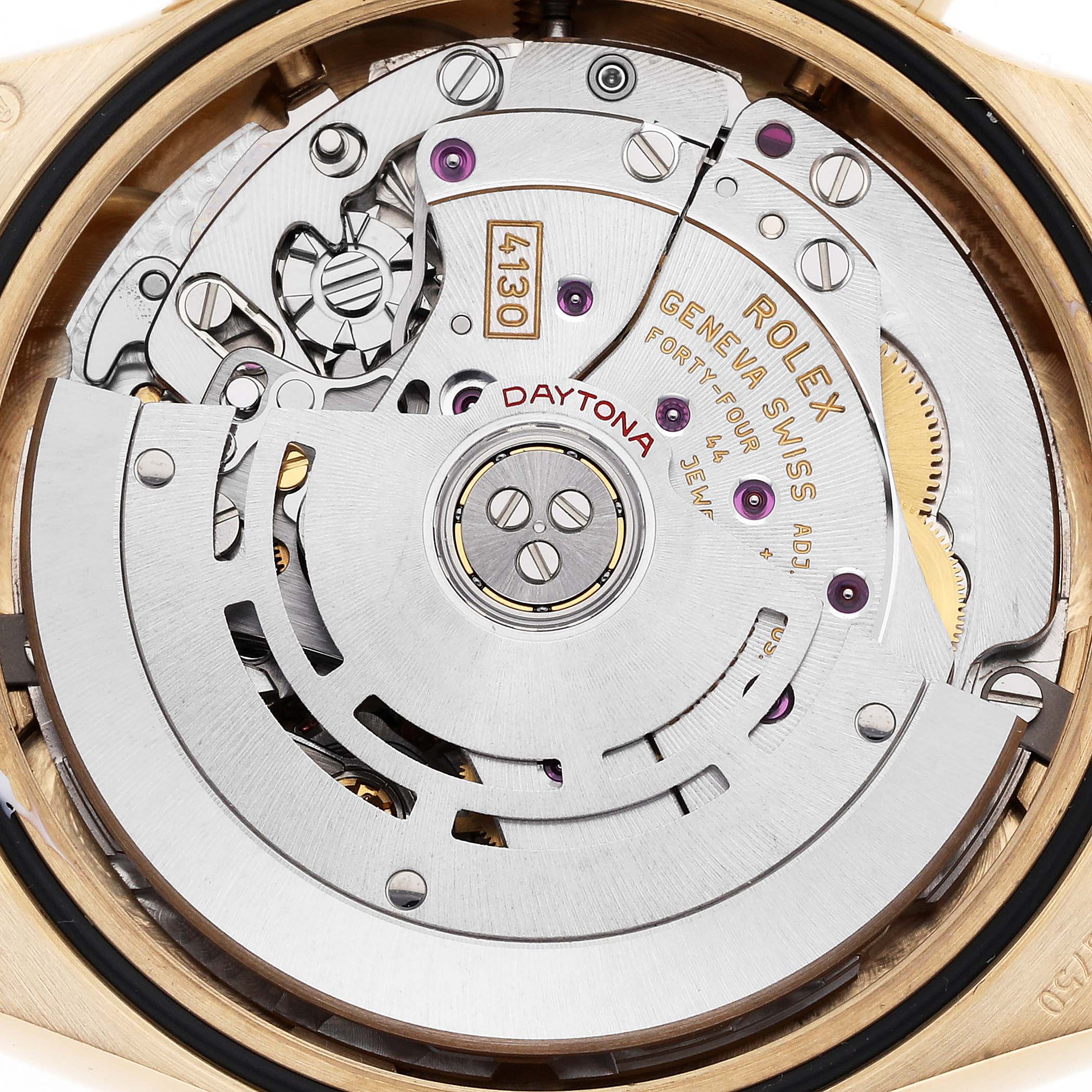 This image shows a close-up view of the movement inside a Rolex Daytona, model 116508, highlighting gears, the rotor, and inscriptions.
