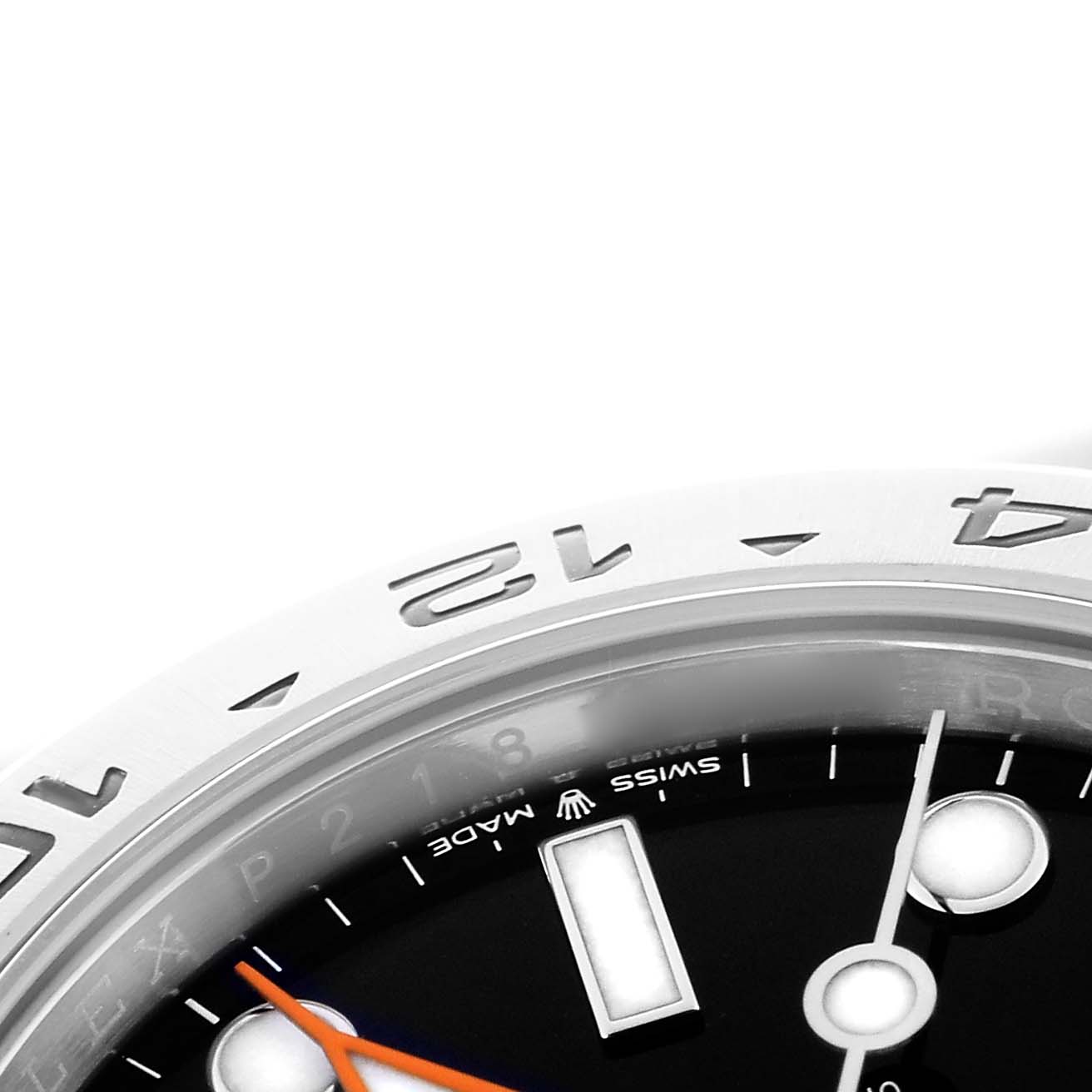 The image shows a close-up of the dial and bezel of a Rolex Explorer model 226570, featuring the 12 and 24-hour markings and part of the hour and second hands.