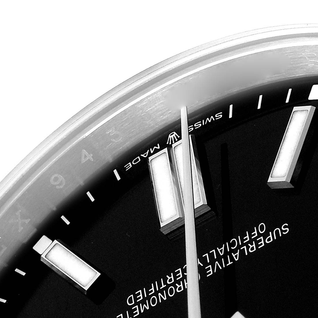 The image shows a close-up of the Rolex Oyster Perpetual model 124300, focusing on the dial edge, markers, and hands at an oblique angle.