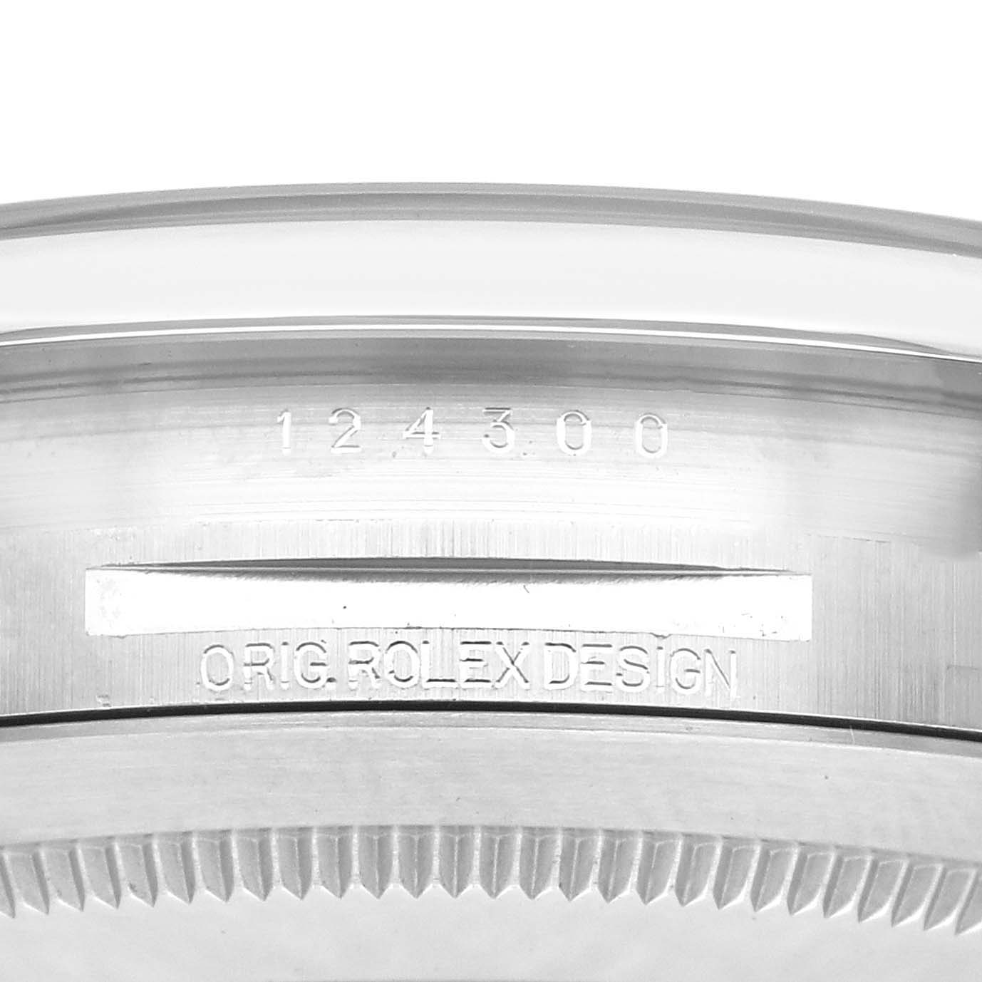 The image shows the side view of a Rolex Oyster Perpetual watch, model number 124300, featuring the engraved bezel and case details.