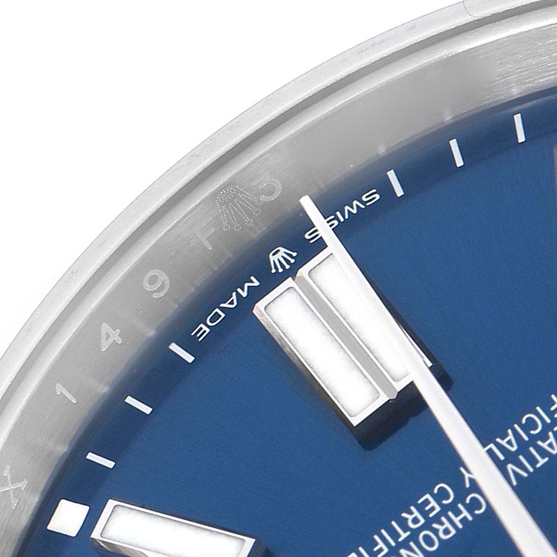 The image shows a close-up of the dial of a Rolex Oyster Perpetual model 124300 men
s watch, focusing on the markers and the "Swiss Made" text.