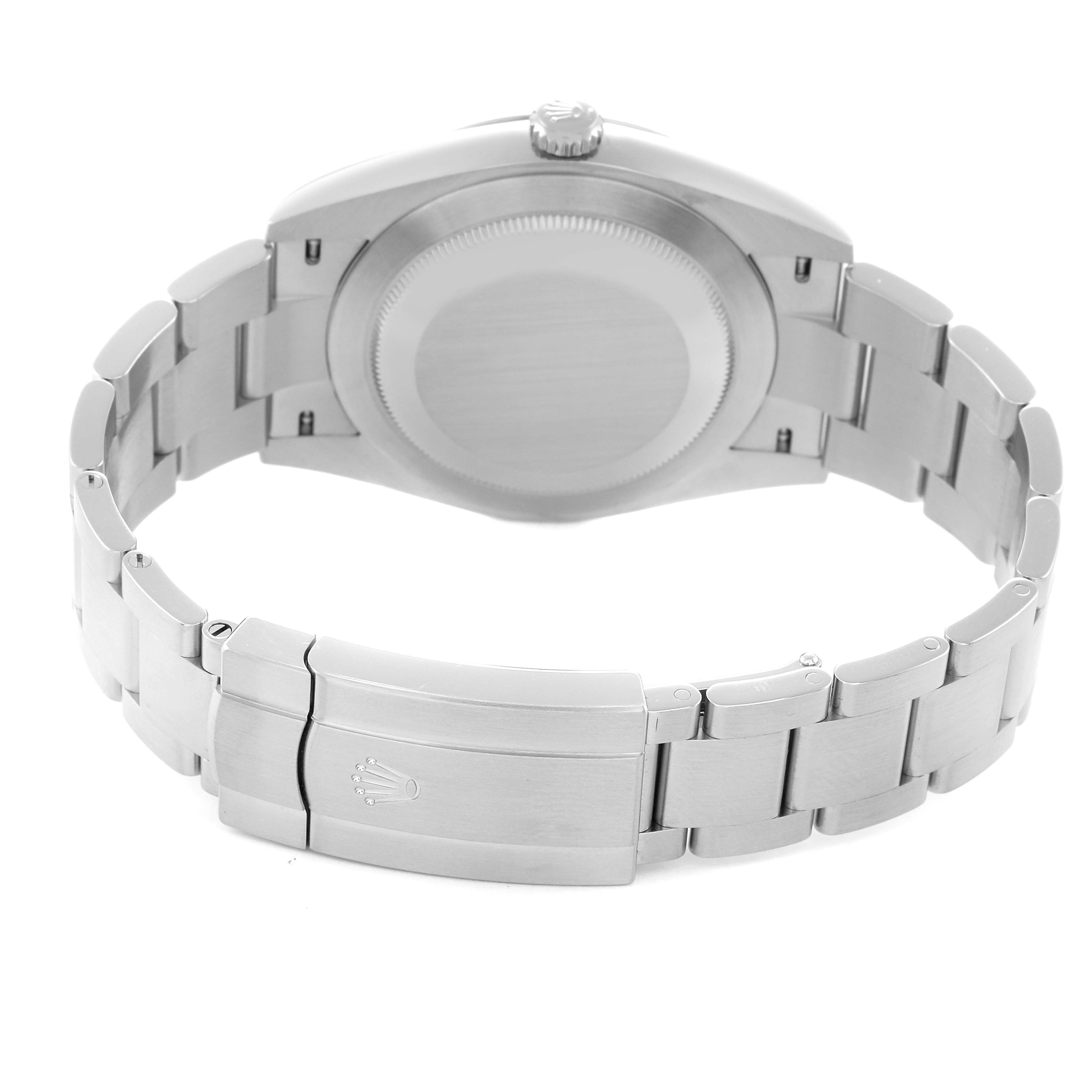 The image shows the back view of the Rolex Oyster Perpetual model 124300, highlighting its case back, bracelet, and clasp with the Rolex logo.