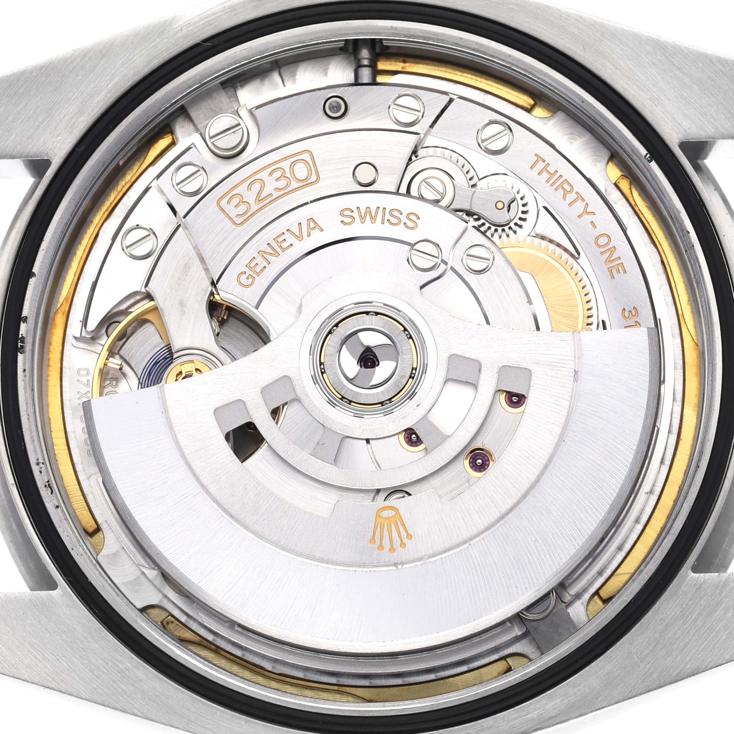 The image shows the movement of a Rolex Oyster Perpetual model 124300, featuring its intricate internal components from a back angle.