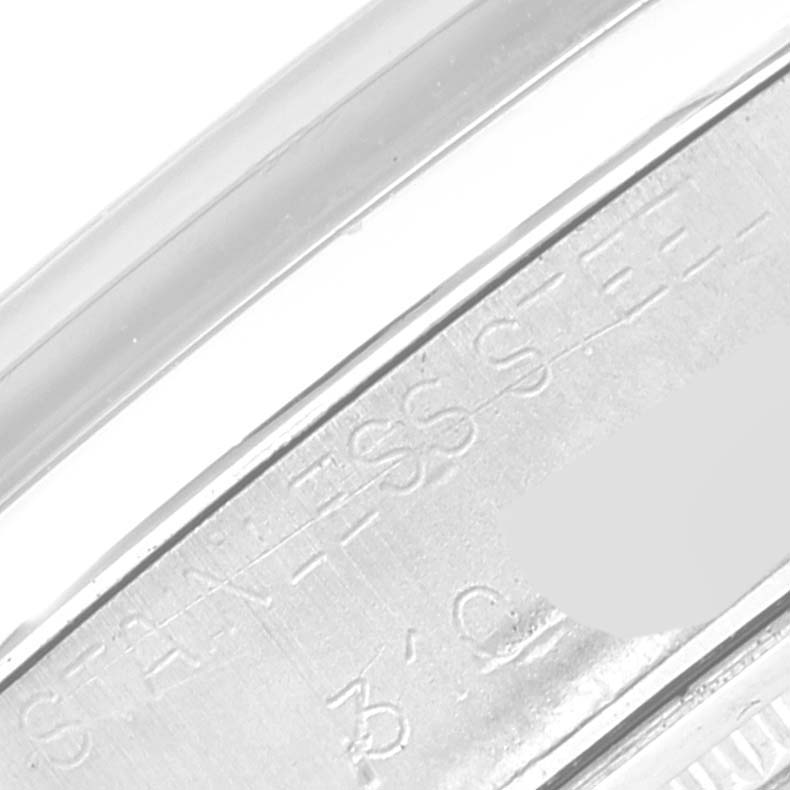 This close-up image shows the engraved "STAINLESS STEEL" marking on the side of a Rolex Vintage Collection 6694 Men's Stainless Steel Silver Dial 6694 Men's Stainless Steel Silver Dial watch case.