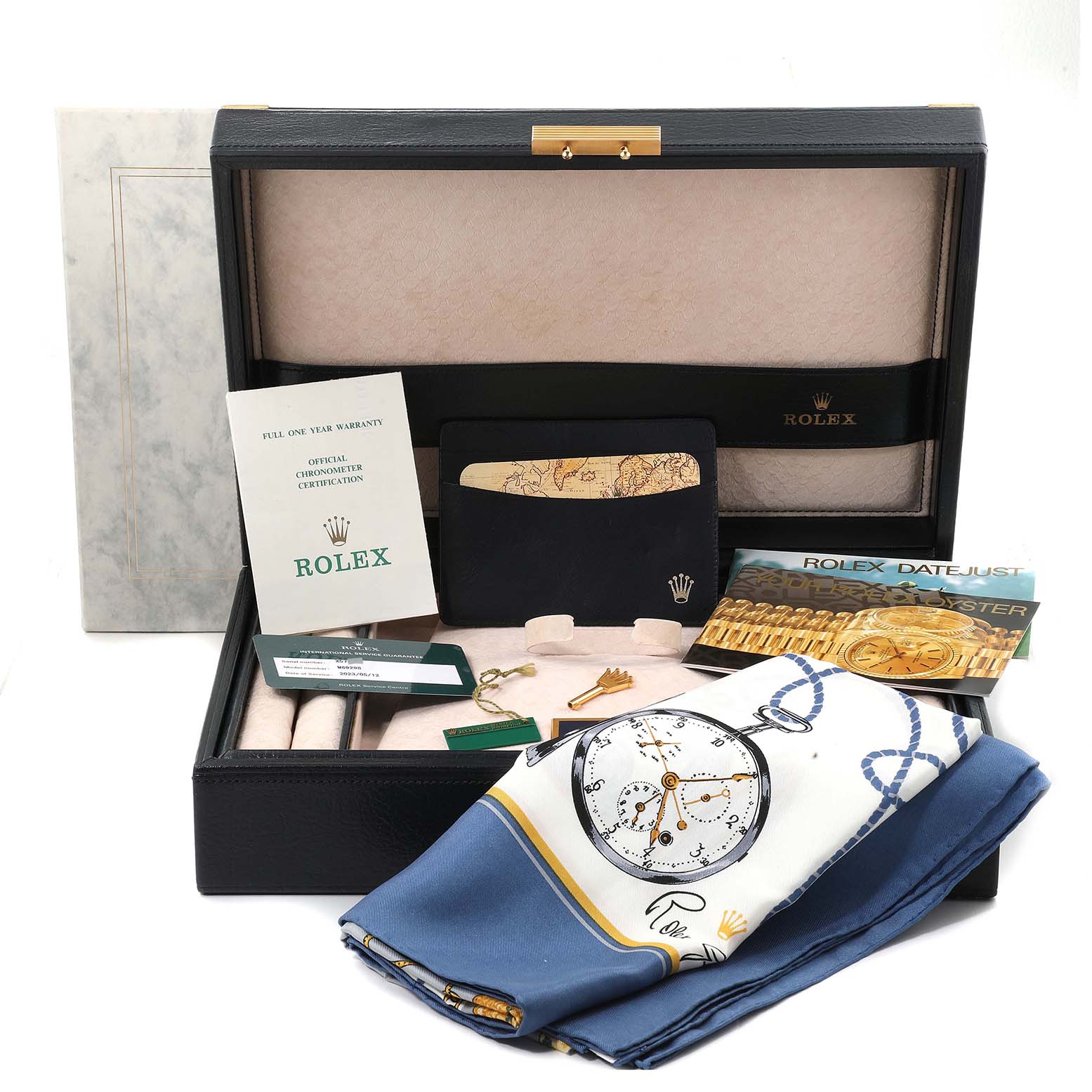The image shows the packaging and accessories of a Rolex Pearlmaster 69298 Women's Yellow Gold Mother of Pearl Dial 69298 Women's Yellow Gold Mother of Pearl Dial watch, including documents, a cloth, and a presentation box.
