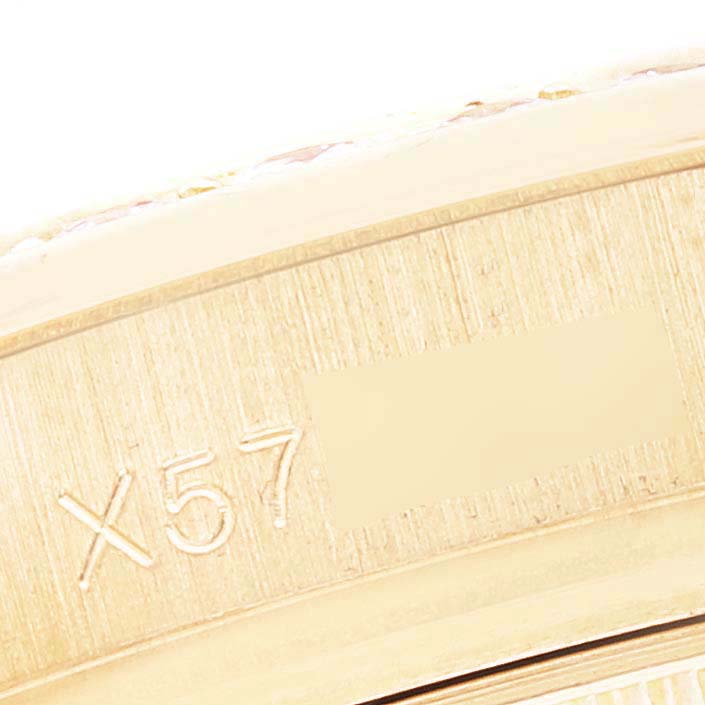 This close-up angle shows a part of the Rolex Pearlmaster 69298 Women's Yellow Gold Mother of Pearl Dial 69298 Women's Yellow Gold Mother of Pearl Dial watch's casing with an engraved serial number.